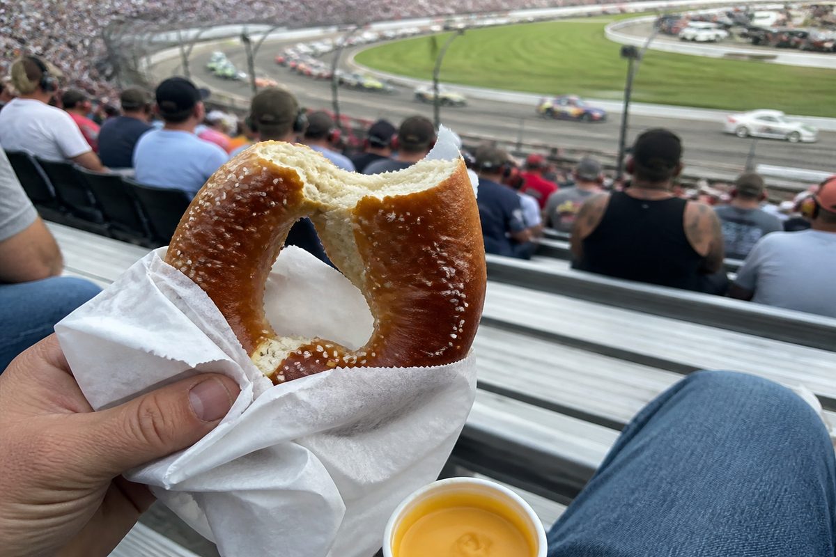 Half-eaten salted pretzel held in the racetrack grandstands